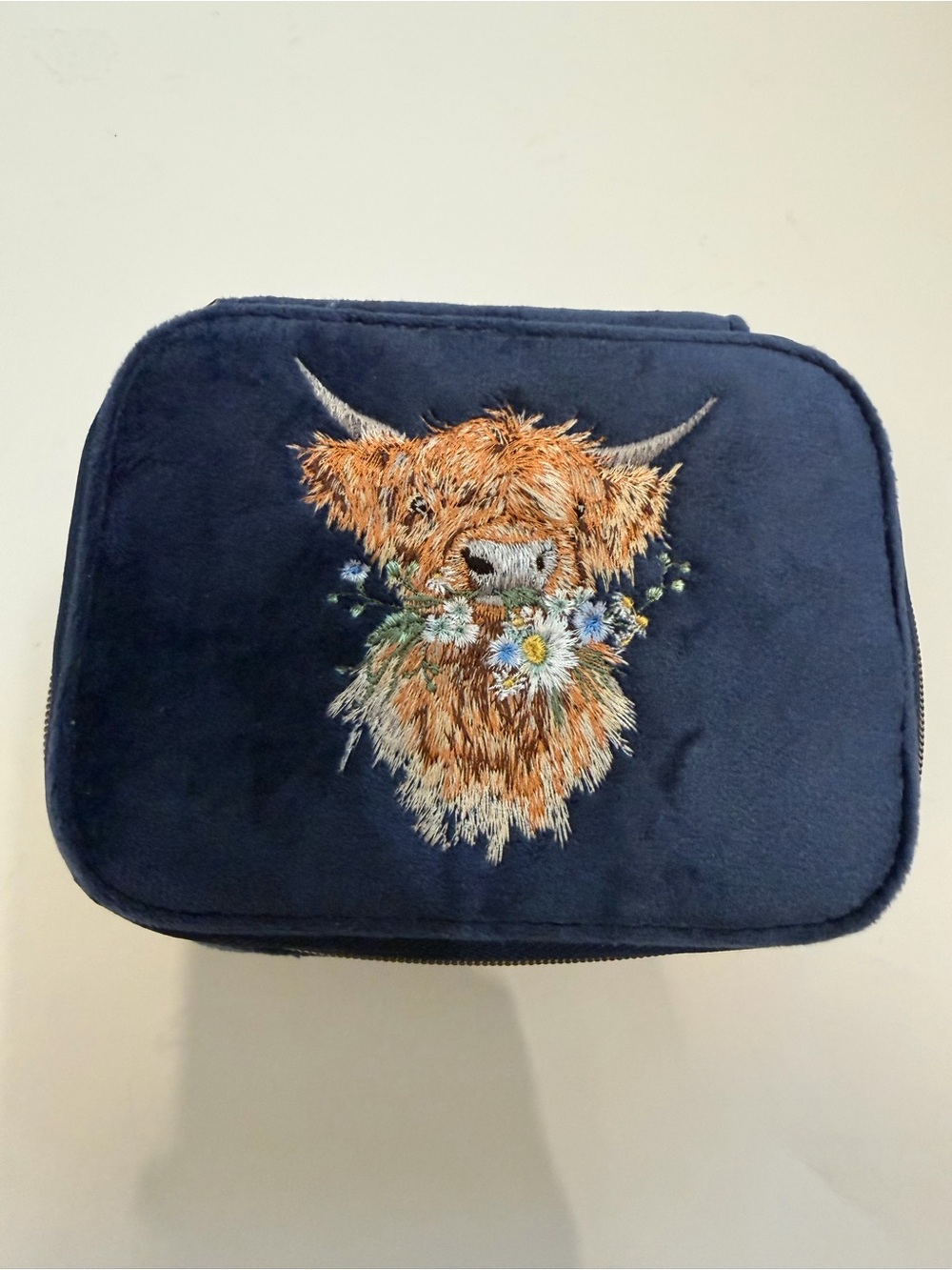 Wrendale “daisy coo” highland cow accessory case.